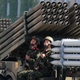Soldiers riding a multiple-rocket launcher during the parade.